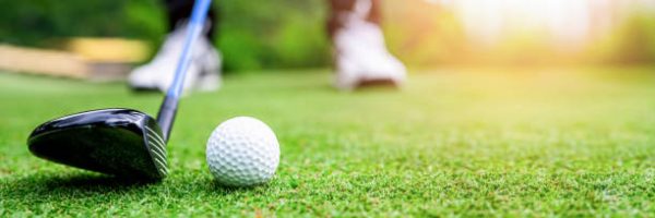 Close up golf ball on green grass field. sport golf club