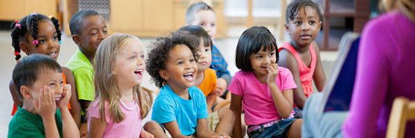 Preschool children in a classroom for story time.