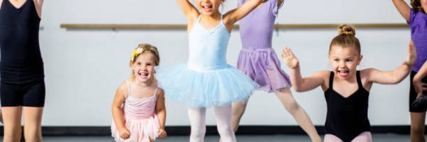A diverse young group of students practice in musical theatre and ballet combo dance class